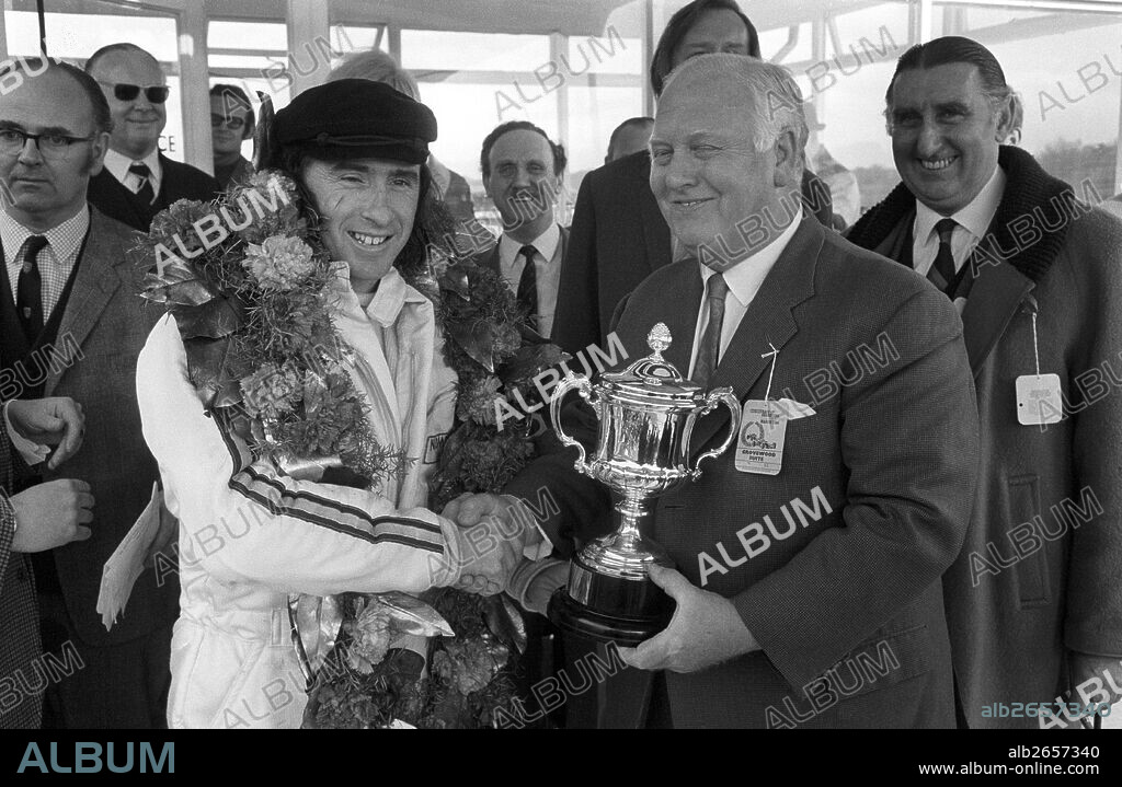 Jackie Stewart won the Race of Champions in a March-Cosworth, eminent race commentator Anthony Marsh standing left. Brands Hatch, England, 22 March 1970.