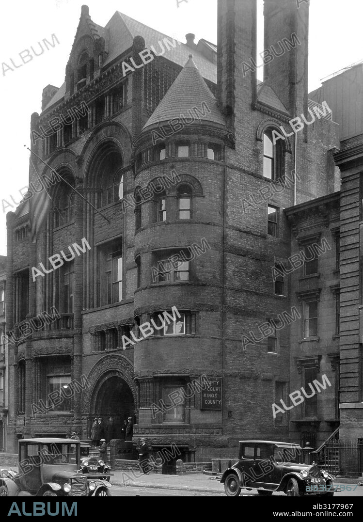 New York, New York:  c. 1920 Built in 1865, Brooklyn's Kings County Courthouse is alive in the details, including tall dual chimneys and a round tower with peaked roof. New York's Supreme Court met here.   © Underwood Archives / The Image Works.