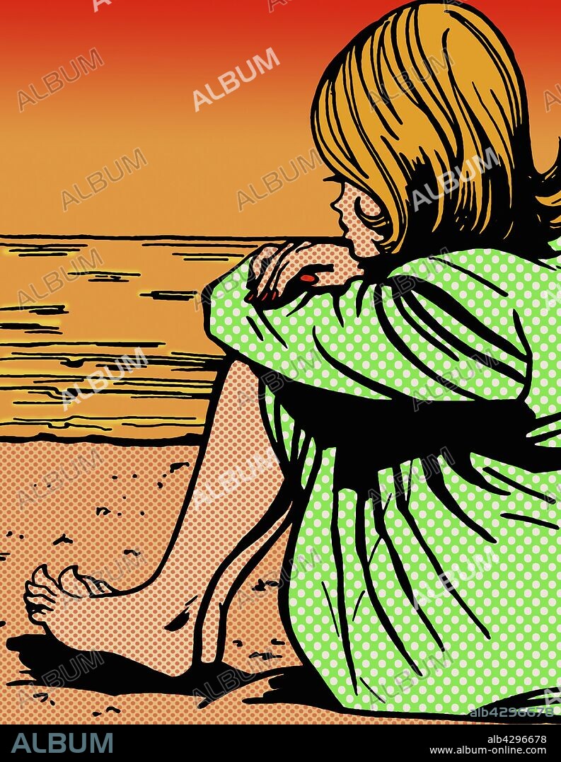 Sad woman hugging knees looking out to sea.
