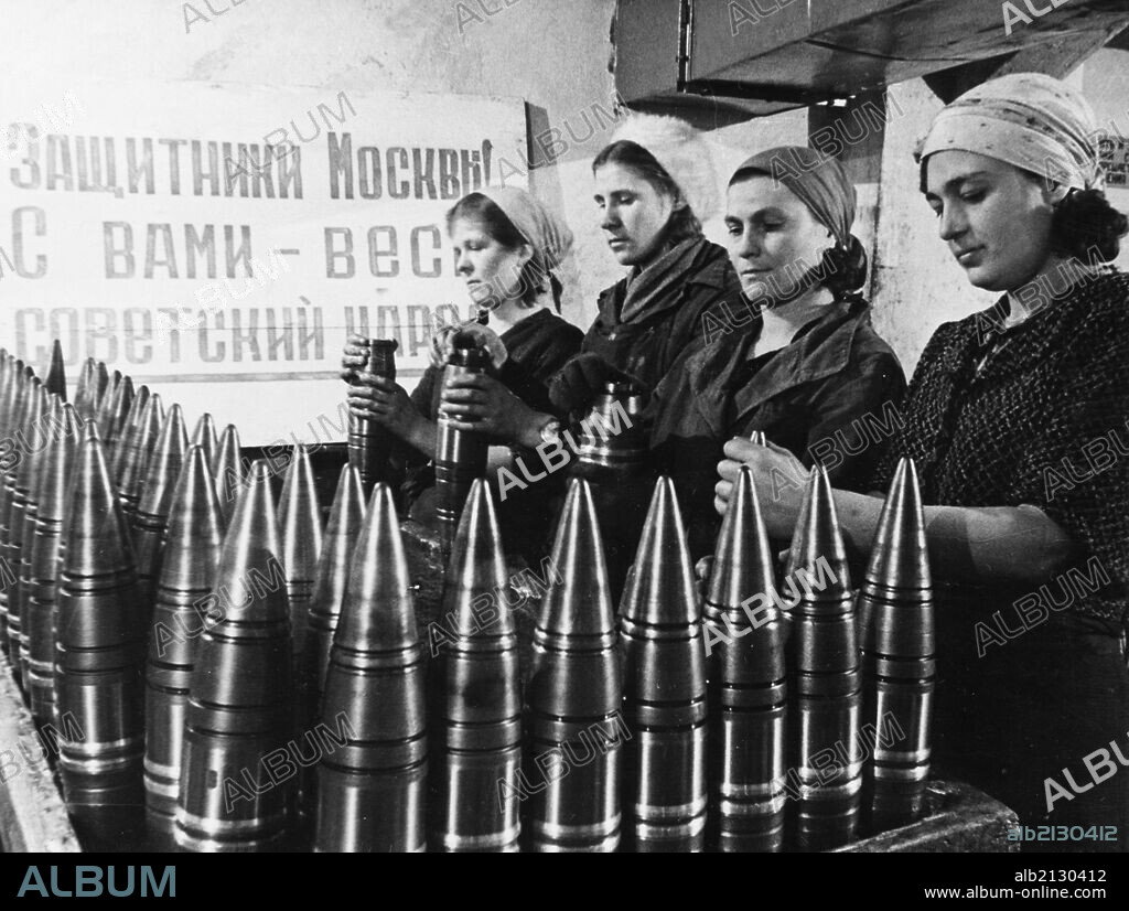 Civilian women making artillery shells at a munitions factory in moscow during world war 2, the sign behind them reads: 'defenders of moscow! the soviet people are with you! '. 01/02/2013