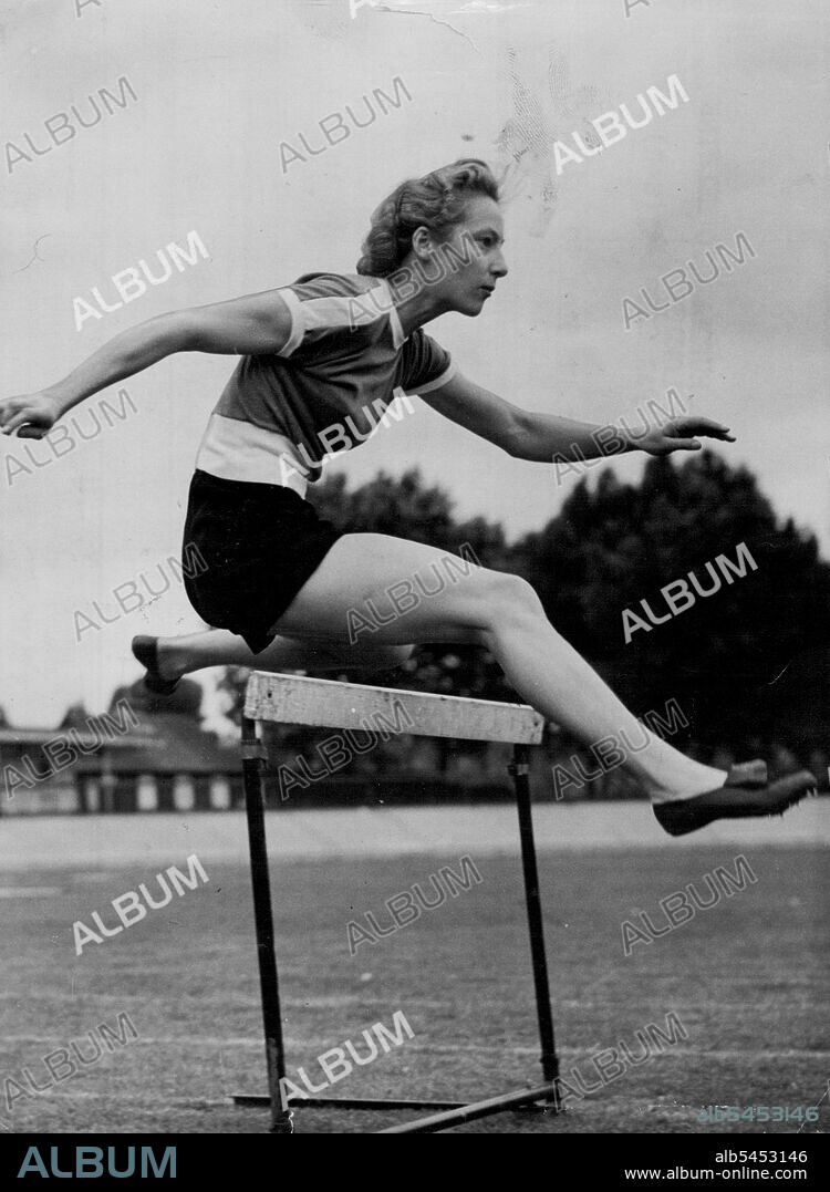 Australian Girl Hurdles To Helsinki Via London -- Miss Shirley Strickland (Western Australia), one of Australia's women athletes for the Olympic Games, practising over the hurdles at Paddington Track, London, today (Thursday).The Australian athletes are in London on their way to Helsinki. Miss Strickland is a 100 and 200-metres sprinter as well as a hurdler. June 19, 1952. (Photo by Reuterphoto).