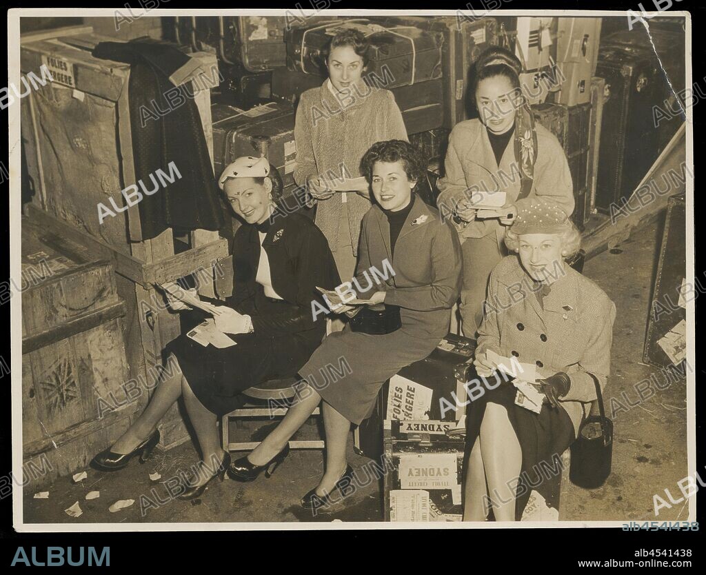Photograph - Bernice Kopple and four Folies Bergere Dancers, Australia, 1950s, Photograph of Bernice Kopple (centre) and four other dancers of the Folies Bergere Show on the Tivoli Circuit tour in Australia,1950s, in street clothes seated among suitcases, probably backstage before going to Sydney. In the 1950s and 1960s Bernice Kopple worked as a fashion photographic model and as a performer on the Tivoli Circuit. Bernice Kopple was born in Glasgow, Scotland in 1930.