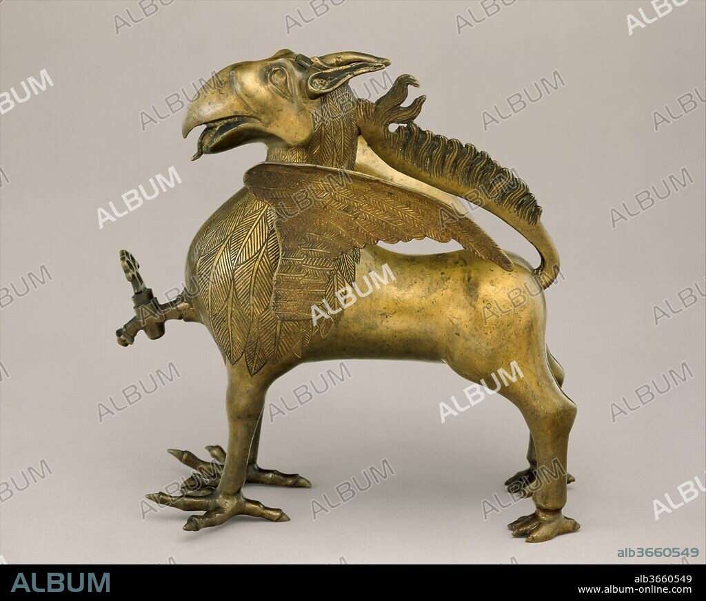 Aquamanile in the Form of a Griffin. Culture: German, Nuremberg. Dimensions: H. 31.9 cm, w. 12 cm (chest without wings), l. 32.3 cm
(including spout), wt. 3588 g and 488 g (wings).. Date: ca. 1425-50.
This magnificent aquamanile in the form of a griffin with (separately cast) outstretched wings can be grouped stylistically with the unicorn (64.101.1493) and a few other examples that were probably produced by the same Nuremberg workshop in the second quarter of the fifteenth century. The aquamanile was filled through a hole between the ears, and water was poured from the spigot in the chest, likely a rare surviving original element.