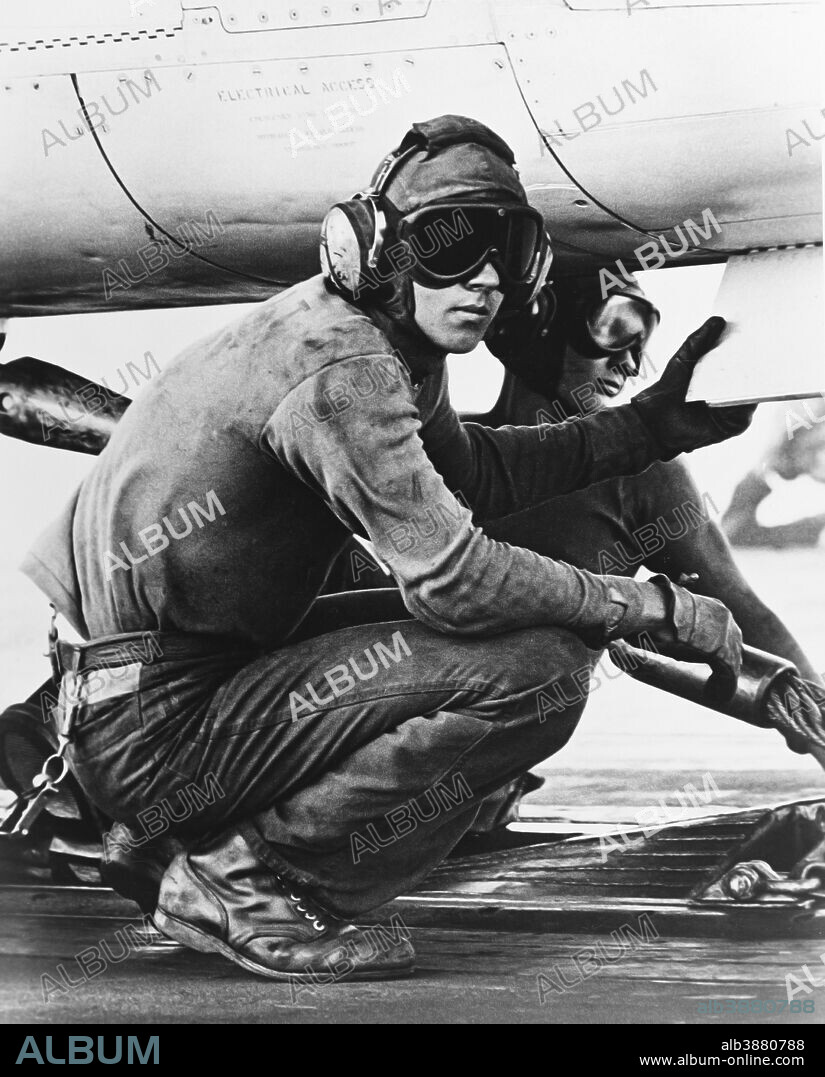 April 1967 - Catapult crewmen pause after hooking up the launch cable to an aircraft aboard USS Hancock (CVA-19), in the South China Sea.