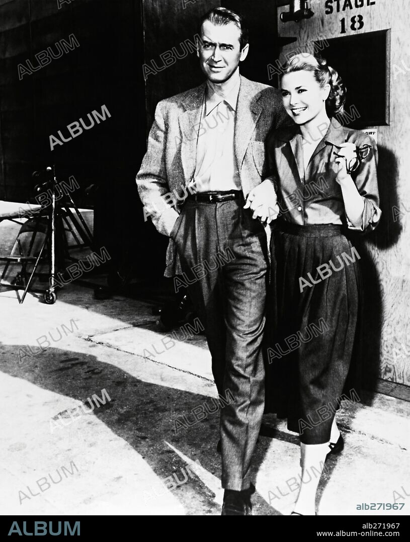 GRACE KELLY and JAMES STEWART in REAR WINDOW, 1954, directed by ALFRED HITCHCOCK. Copyright PARAMOUNT PICTURES.