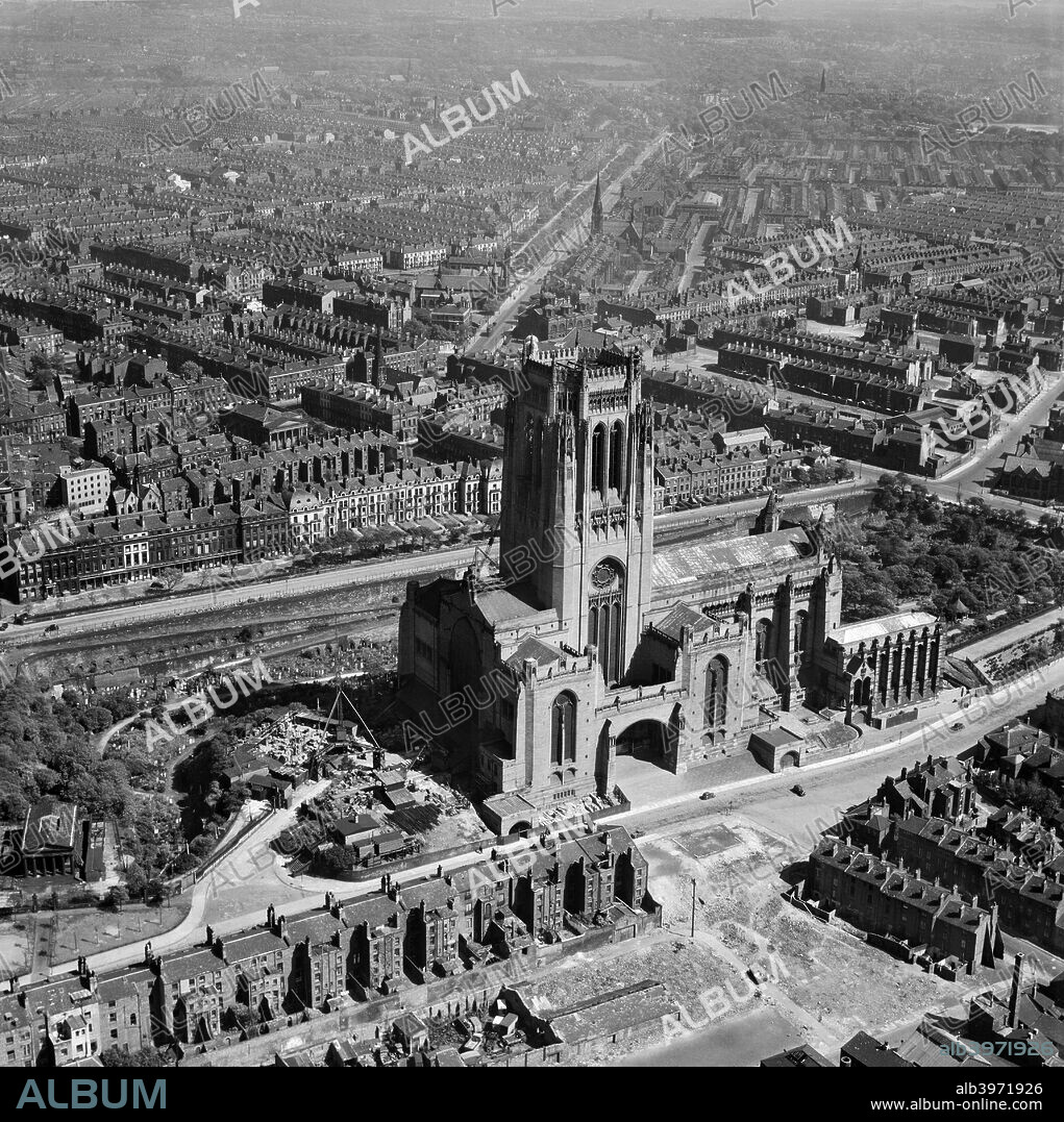 Liverpool Cathedral, Merseyside, May 1949. The Anglican cathedral in Liverpool was begun in 1904 to a design of Giles Gilbert Scott. The tower was completed in 1942, but the cathedral was not completed until 1978. Seen here from the air, the nave and west front are still to be completed.
