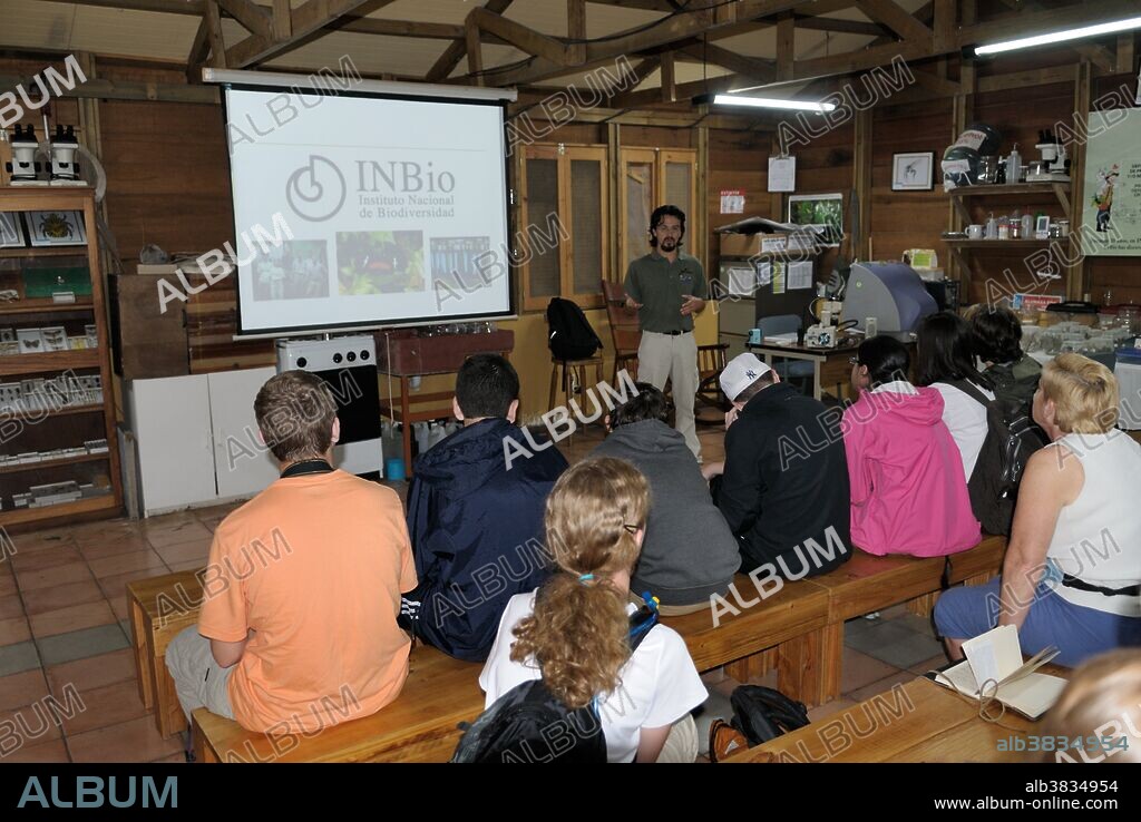 Ecology, environment presentation at INBio Parque, Costa Rica. INBio is the National Institute of Biodiversity - an organization devoted to studying and cataloguing Costa Rica's many organisms. A researcher is giving a presentation on biodiversity to a group of American ecotourists.