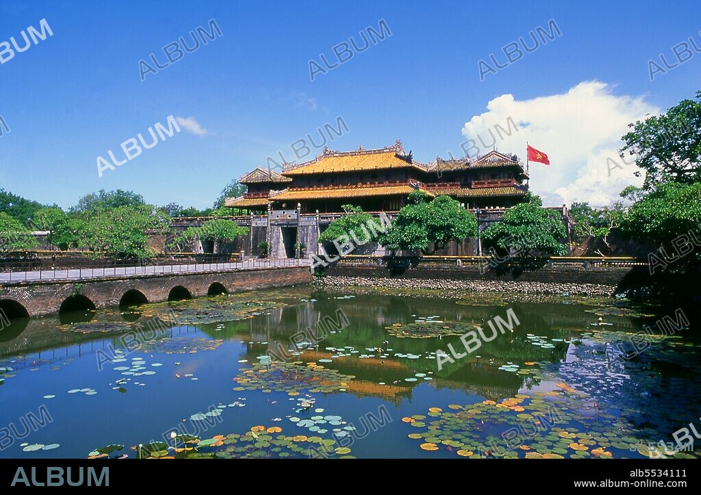 The Ng? Môn (Chinese character: ??), also known as the Gate of Noon, is the main gate to the Imperial City, Hu?, located within the citadel of Hu?. It was built in 1833 in the traditional Vietnamese Nguyen style under the rule of Emperor Minh Mang. Emperor Gia Long ordered the construction of Hue Citadel in 1805. The vast complex is built according to the notions of fengshui or Chinese geomancy, but following the military principles of the noted 18th century French military architect Sebastien de Vauban. The result is an unusual and elegant hybrid, a Chinese-style Imperial City carefully aligned with surrounding hills, islands and waterways, but defended by massive brick walls between 6-12 metres high and 2.5 metres thick, punctuated by towers, ramparts, a massive earth glacis, and 24 Vauban-inspired bastions. The entire complex was further protected by wide moats, crossed by gracefully arched stone bridges leading to ten gates, the chief of which is Cua Ngo Mon, the south-east facing ‘Meridian Gate’. To compound the exotic hybrid effect, guard posts designed as Chinese-style miradors, complete with sweeping eaves crowned by imperial dragons, surmounted each gate. Finally, directly in front of the Ngo Mon Gate, a massive brick fort 18 metres high was constructed both as an additional barrier against malign spirits, and as a defensive redoubt. The area within the Citadel - in all, 520 hectares (1300 acres) - comprises three concentric enclosures, the Civic, Imperial and Forbidden Purple Cities. Access is by way of ten fortified gates, each of which is reached by a low, arched stone bridge across the moat. In imperial times a cannon would sound at 5am and 9pm to mark the opening and closing of the gates. Hue was the imperial capital of the Nguyen Dynasty between 1802 and 1945. The tombs of several emperors lie in and around the city and along the Perfume River. Hue is a UNESCO World Heritage Site.