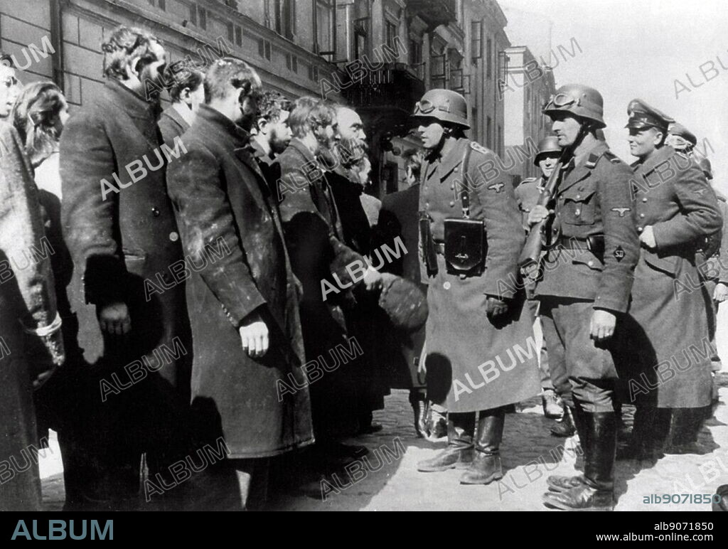Photograph from Nowolipie Street with Josef Blösche (1912-1969) member of the National Socialist German Workers Party, stopping Jewish Rabbis. Dated 1940.