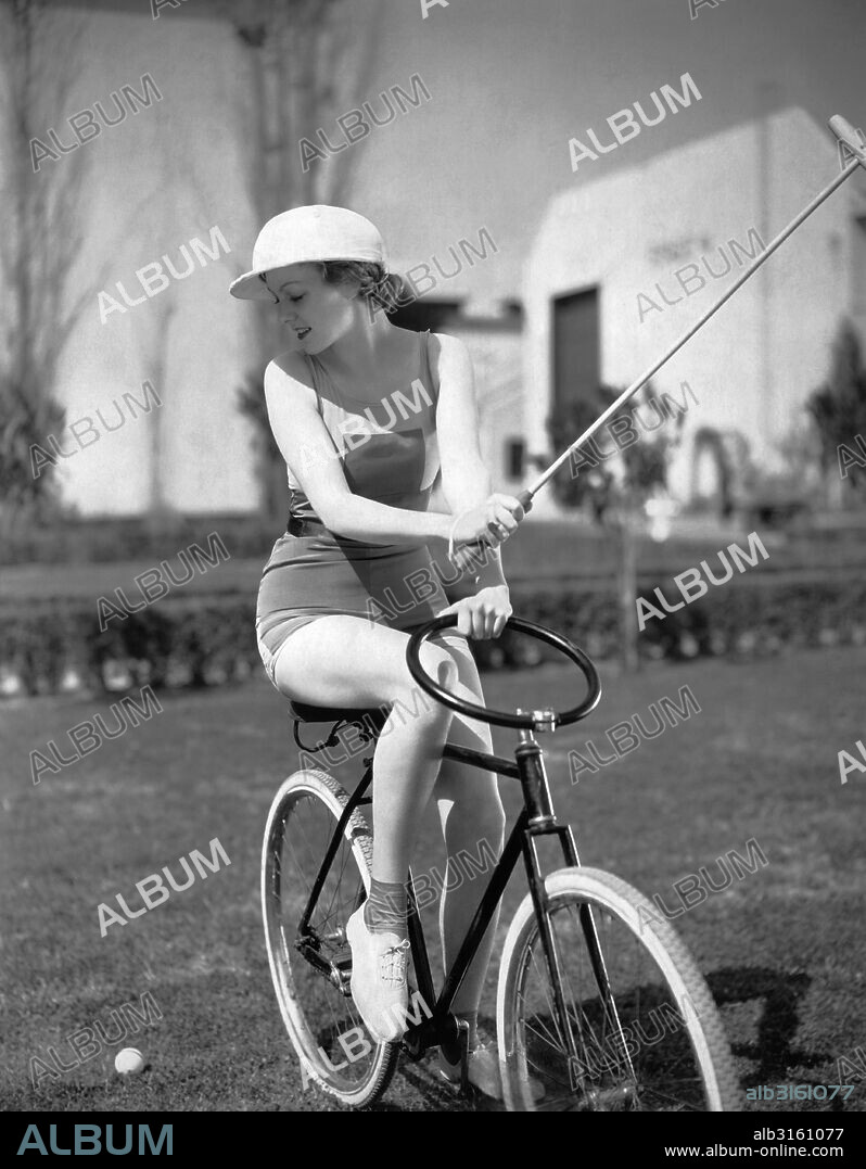 Hollywood, California: August, 1931 Movie star Claire Dodd plays bike polo with a special ring-shaped handlebar on her bicycle.