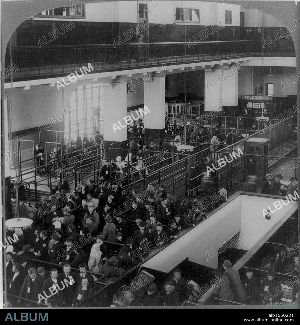 Immigrants just arrived in the USA from Europe waiting to be processed in the immigrant building, Ellis Island, New York.