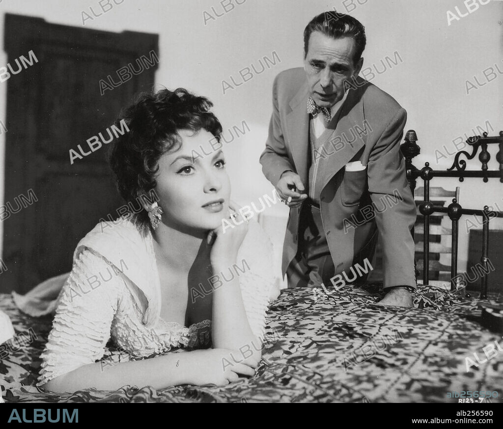 GINA LOLLOBRIGIDA and HUMPHREY BOGART in BEAT THE DEVIL, 1953, directed by JOHN HUSTON. Copyright UNITED ARTISTS.