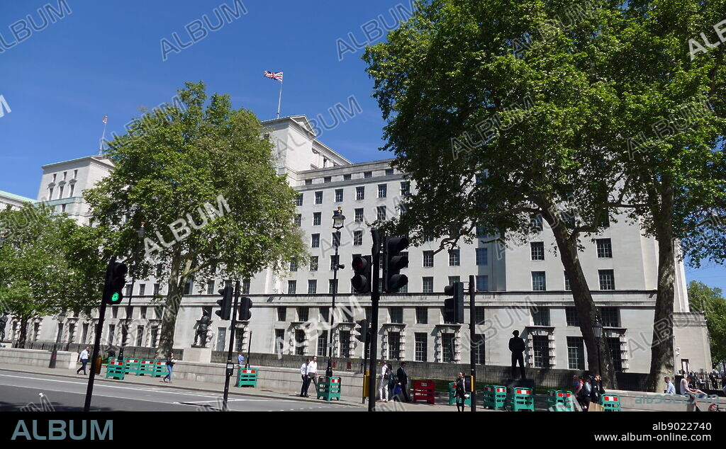 The headquarters of the MOD are in Whitehall and is known as MOD Main Building. This structure is neoclassical in style and was originally built between 1938 and 1959 to designs by Vincent Harris. The Ministry of Defence (MOD or MoD) is the British government department responsible for implementing the defence policy set by Her Majesty's Government and is the headquarters of the British Armed Forces.