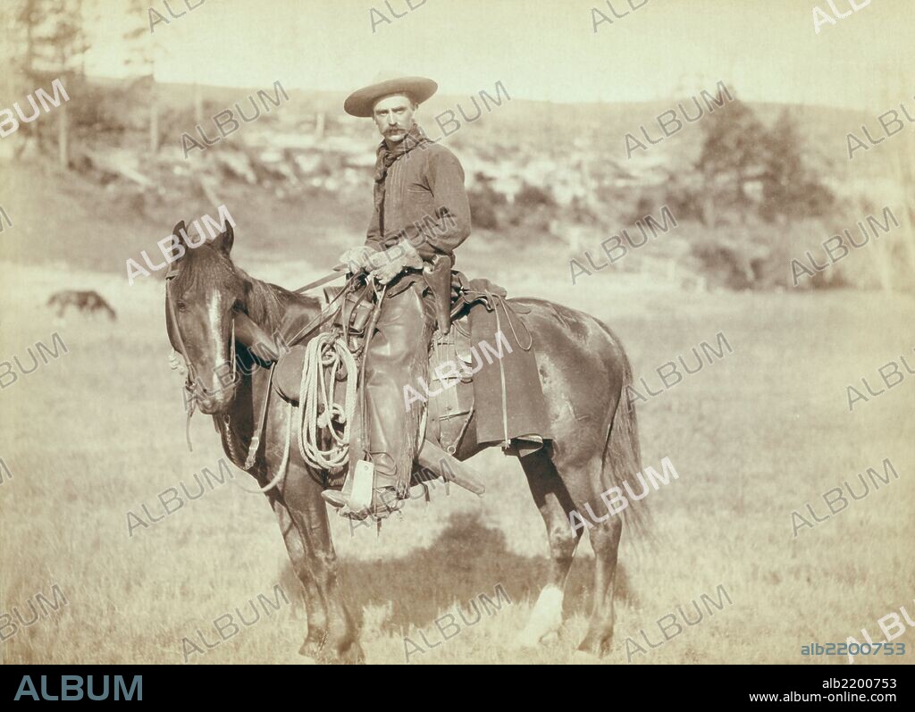 side view of a cowboy on a horse, looking towards the camera.