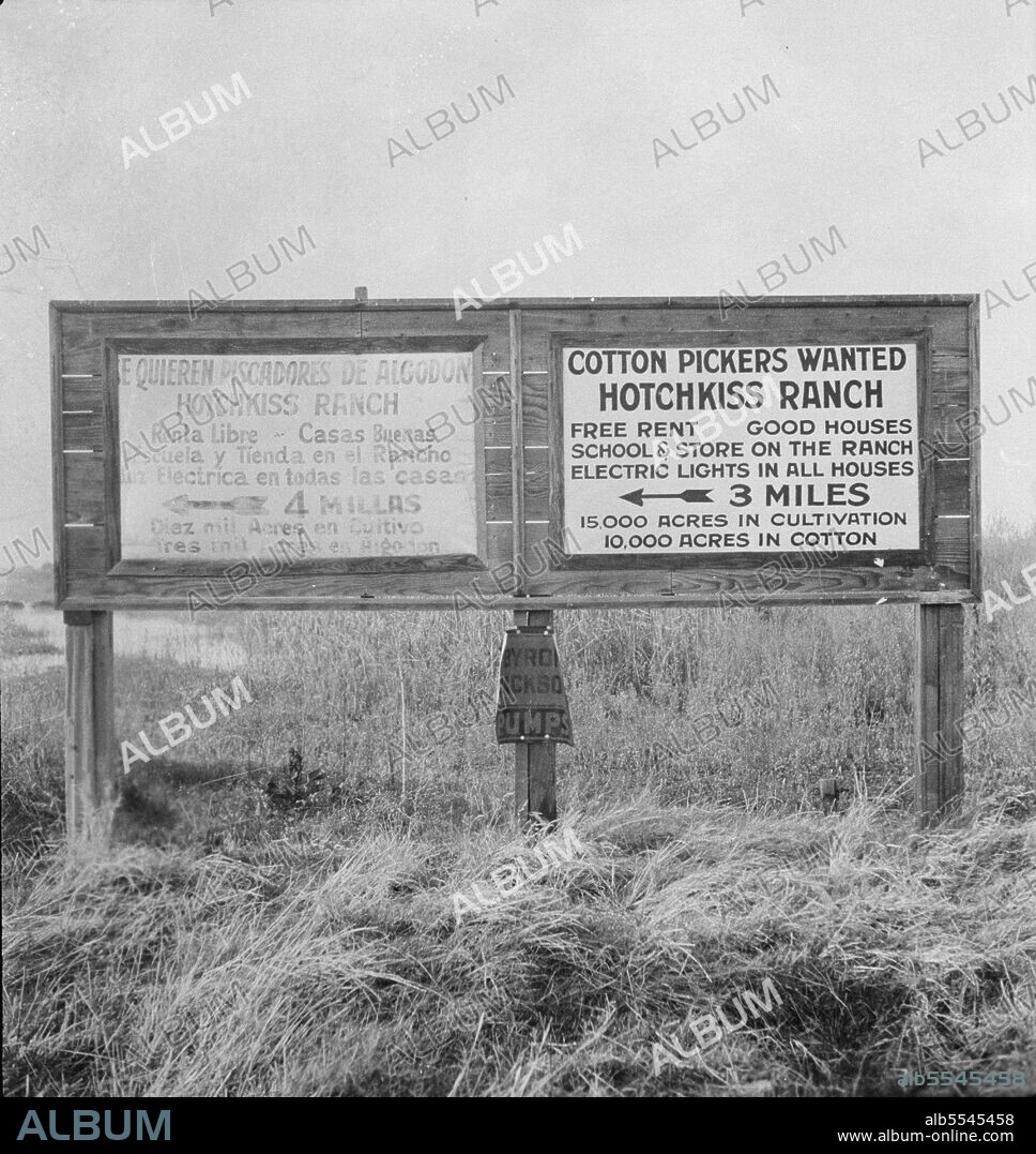 DOROTHEA LANGE. Employment signs in Spanish and English. These ranches (1938) increasingly use Negro pickers. Near Fresno, California. [Spanish sign (painted out): 'Se Quieren Piscadores de Algodon - Hotchkiss Ranch - Renta Libre - Casas Buenas - Escuela y Tienda en el Rancho - Luz Electrica en todas las casas - 4 Millas - Diez Mil Acres en Cultivo - Tres Mil Acres en Algodon'. English: 'Cotton Pickers Wanted - Hotchkiss Ranch - Free Rent - Good Houses - School & Store on the Ranch - Electric Lights in all Houses - 3 Miles - 15,000 Acres in Cultivation - 10,000 acres in Cotton'].