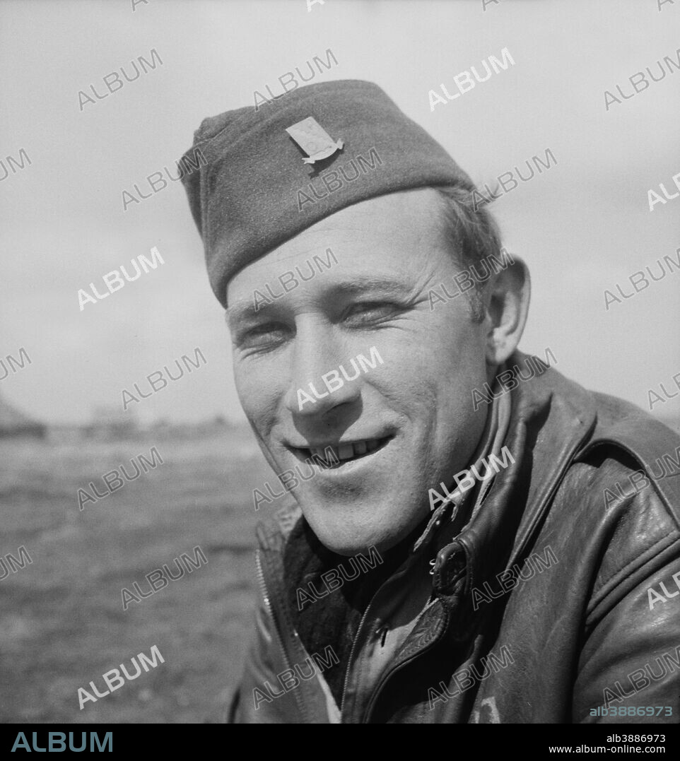 Technical Sergeant Kermit M. Gregory, radio operator of the Snow White, a B-24 bomber of the U.S. Army 9th Air Force in Tunisia. He is one of the original crew members that brought this bomber across the Atlantic and then completed thirty-six missions over enemy targets, piling up 300 hours of combat time. circa 1942-1945.