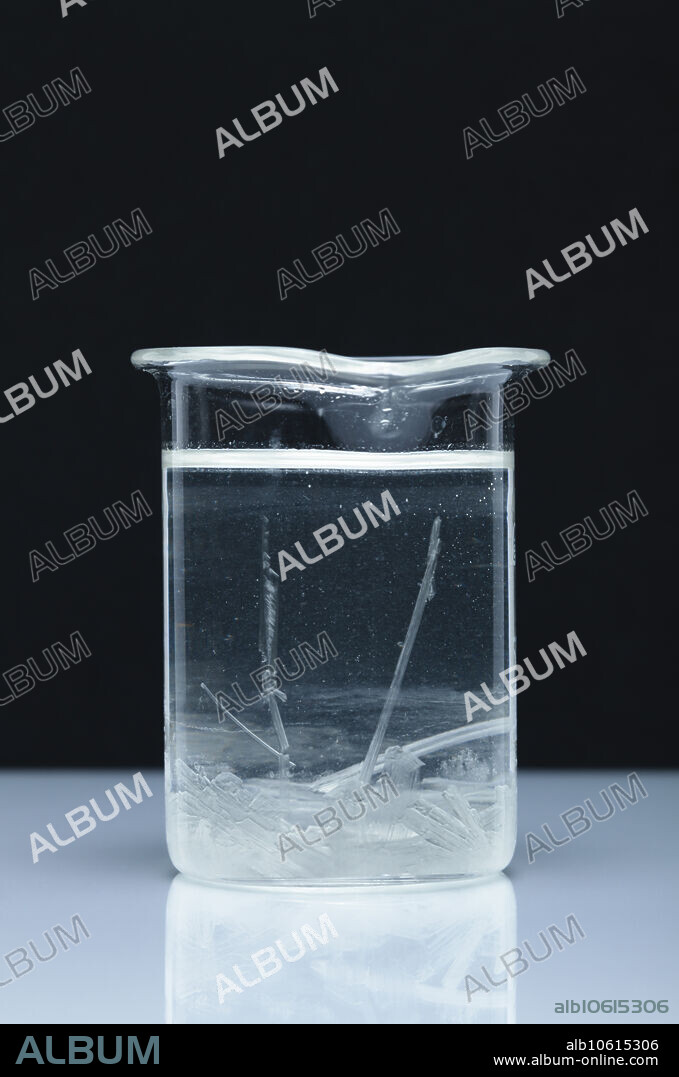 Crystallization of supersaturated sodium acetate. When sodium acetate trihydrate (CH3COONa 3H2O) melts at 58C, it releases bound water (water of crystallization) and dissolves in it. When the solution is allowed to cool slowly, it becomes supersaturated. If a nucleation centre is formed or introduced, it causes the solution to crystallize back into solid sodium acetate trihydrate. This process is exothermic and releases heat. It found its use in consumer heating pads.