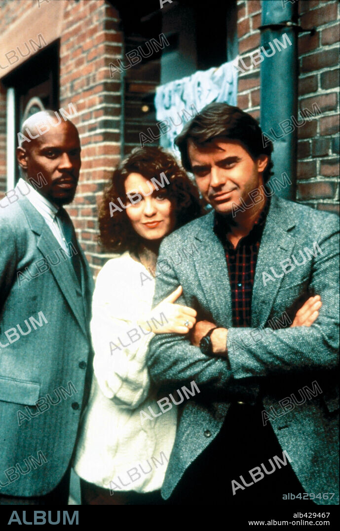 AVERY BROOKS, BARBARA STOCK and ROBERT URICH in SPENSER: FOR HIRE, 1985, directed by RICHARD A. COLLA, VIRGIL W. VOGEL and WILLIAM WIARD. Copyright WARNER BROS TV.