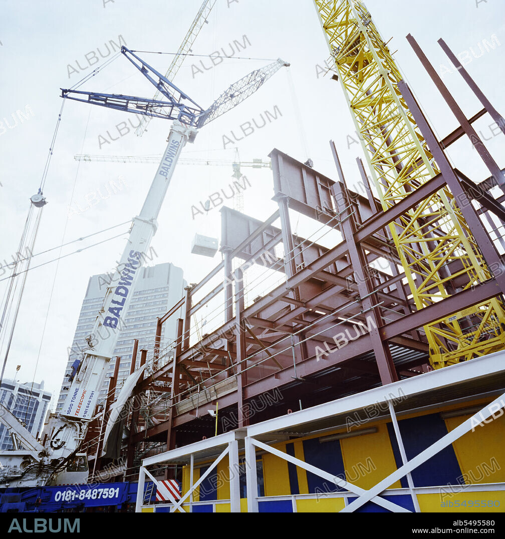 JOHN LAING PLC. Stakis London Metropole Hotel, Edgware Road, City of Westminster, London, 25/04/1999. A view from the base of a large crane during the construction of the steel frame of the extension to the Stakis Metropole Hotel, London. Six plate girders weigh 82 tonnes each and span 26 metres to form the ceiling of the upper ballroom and provide support for 363 bedrooms on nine floors above.  The size of the crane required to lift the girders into place meant road closures were needed.  Laing liaised with a number of agencies including the Traffic and Abnormal Loads Police and the Paddington Basin Construction Impact Team and the installation proceeded with minimal disruption to traffic.