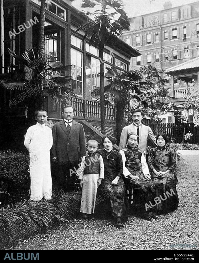 A domestic portrait outside the house at Yokohama Yamate-cho 59: Charles Soong is standing second from left. Front row from left:  Song Zian, Soong Ching-ling, Ni Gui Zhen, Song Ai-ling. Standing behind Song Ailing is a young H.H. Kung. The couple would marry in Yokohama on September 20 1914.