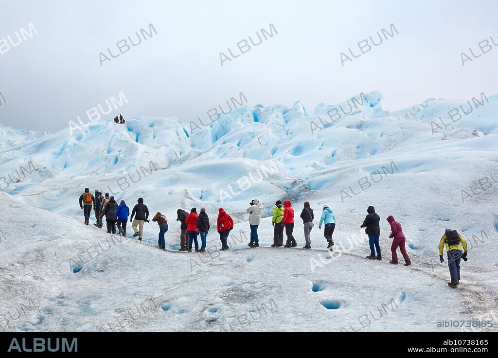 Mini trekking. Walk on the glacier with crampons. Perito Moreno glacier. Los Glaciares National Park. Near EL Calafate. Santa Cruz province. Patagonia. Argentina.