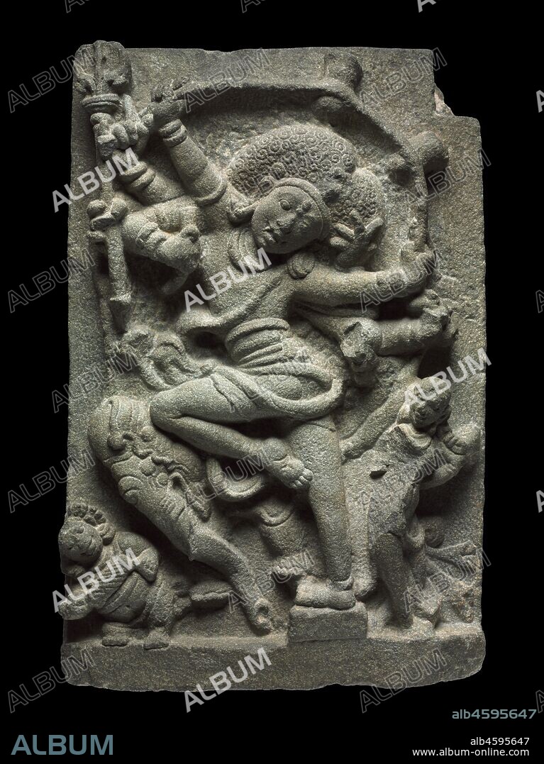 Shiva as Slayer of the Elephant Demon, 1000s. In an exuberant dance posture with eight arms, Shiva is shown here in his wrathful aspect, with disheveled hair, bulging eyes, and fangs. He has just successfully flayed the skin of an elephant demon and triumphantly stretches it out behind him, its two hind feet sticking up at the right corner of the panel. The elephant in rut, in its demonic form, was used as a metaphor for uncontrolled passions that Shiva helps to conquer in the mind of the devotee, so that the devotee can better focus his attentions on the god himself. In the lower left corner, a dwarfish member of Shiva's entourage beats the rhythm of the dance on his drum. His wife, the goddess Parvati, looks on with admiration.