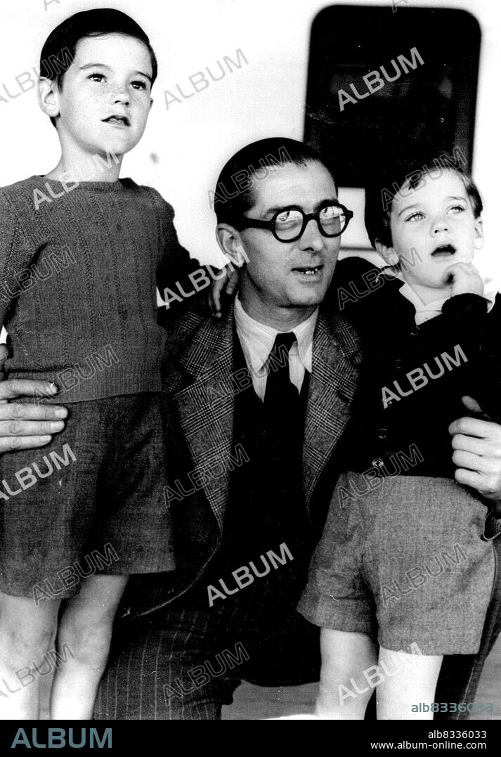 Wimbledon Speedway Rider Norman Parker is pictured on the Stratheden with two young friends he made during the voyage. He is on his way to race in Sydney. November 4, 1947. (Photo by Daily News).