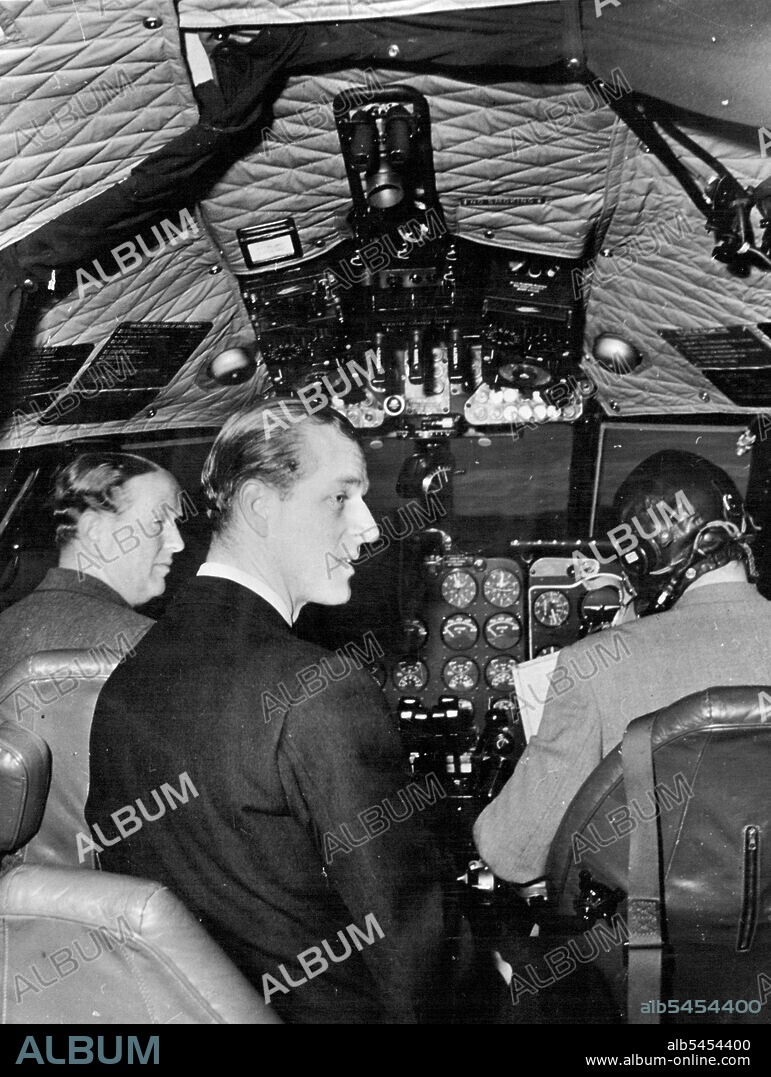 The Duke Of Edinburgh Flies In The World First Jet Air-Liner -- The Duke of Edinburgh sitting in the comet before taking off for a flight which lasted over an hour. On the left is the chief test pilot of de Havillands John Cunningham.The Duke Edinburgh visited the de Havilland Aircraft company at Hatfield where he saw latest design of jet aircraft including the comet jet air-liner which goes into service with B.O.A.C. in May. April 2, 1952. (Photo by United Kingdom Information Service).