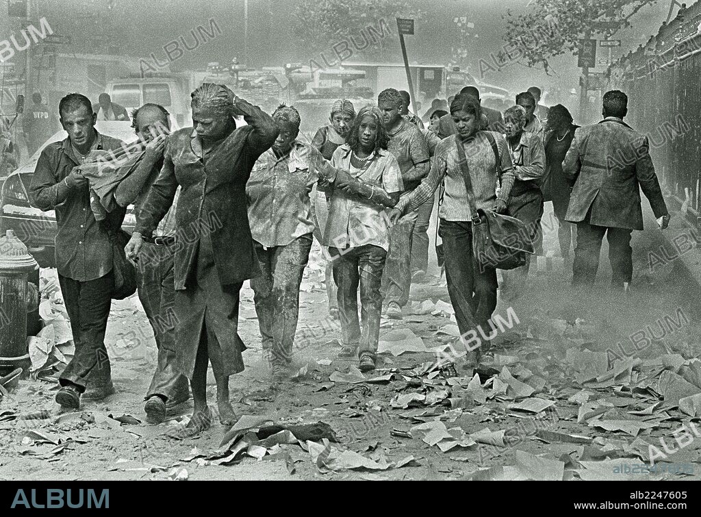 Sept. 11, 2001; New York, New York, U.S.; People covered in ash make their way through dust and debris after the South Tower of the World Trade Center collapsed during Terrorist attacks in New York Tuesday. In the most horrifying attacks ever against the United States, terrorists crashed two airliners into the World Trade center in a deadly series of blows that brought down the twin 110-story towers. (Credit Image: © Gulnara Samoilova/ZUMApress.com). 11/09/2001