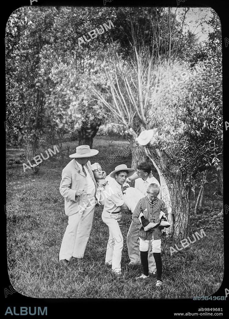 Magic lantern slide circa 1900.Victorian/Edwardian.Social History. A master and children carrying a child for first aid assistance. bandaged head,practice?.