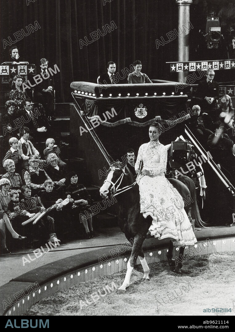 King Carl XVI Gustaf and Queen Silvia of Sweden attending the circus, 1977. King Carl XVI Gustaf (1946-) and Queen Silvia (1943-) watching Danish circus performer Katja Schumann (1949-). From the collection of Svenskt Fotoreportages.