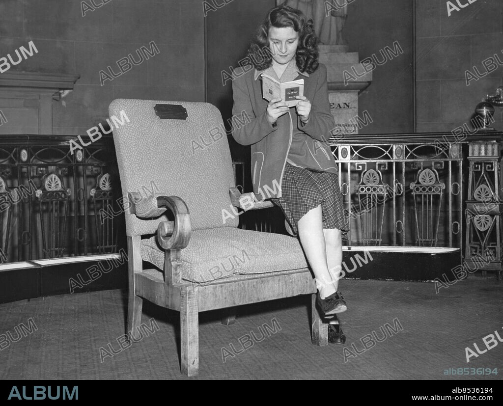 Orig. bildtext... MR DEAN OF E.N.S.A. LEAVES SOUVENIR AT DRURY LANE: HITLER'S CHAIR E.N.S.A. is leaving the Theatre Royal Drury Lane after seven years of occupation. As the whole organisation is moving out, all trace of ENSA's will be gone on Saturday. But ENSA is to leave one souvenir to Drury Lane. It is one of Hitler's chairs which Mr. Dean, Director-General of ENSA found in the burned-out Berlin Reich Chancellery, during one of his tours of Germany. He bought it, has had it re-upholsters and an incredible silver plate has been put on it commemorating E.N.S.A.'s use of Drury Lane's most famous theatre. Photo shows: Hitler's Chair, presented as a souvenir to Theatre Royal, Drury Lane, by Mr. Basil Dean, Director-General of E.N.S.A. persons: Adolf Hitler* sites: STORBRITANNIEN.