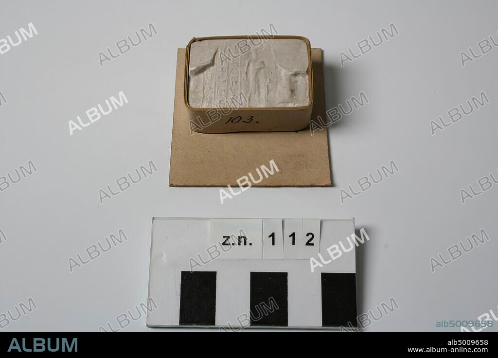 Ancient Near East, imprint, cylinder seal, plaster, 2.5 x 3.7 x 1.4 cm, cardboard, 5.1 x 4.9 cm.