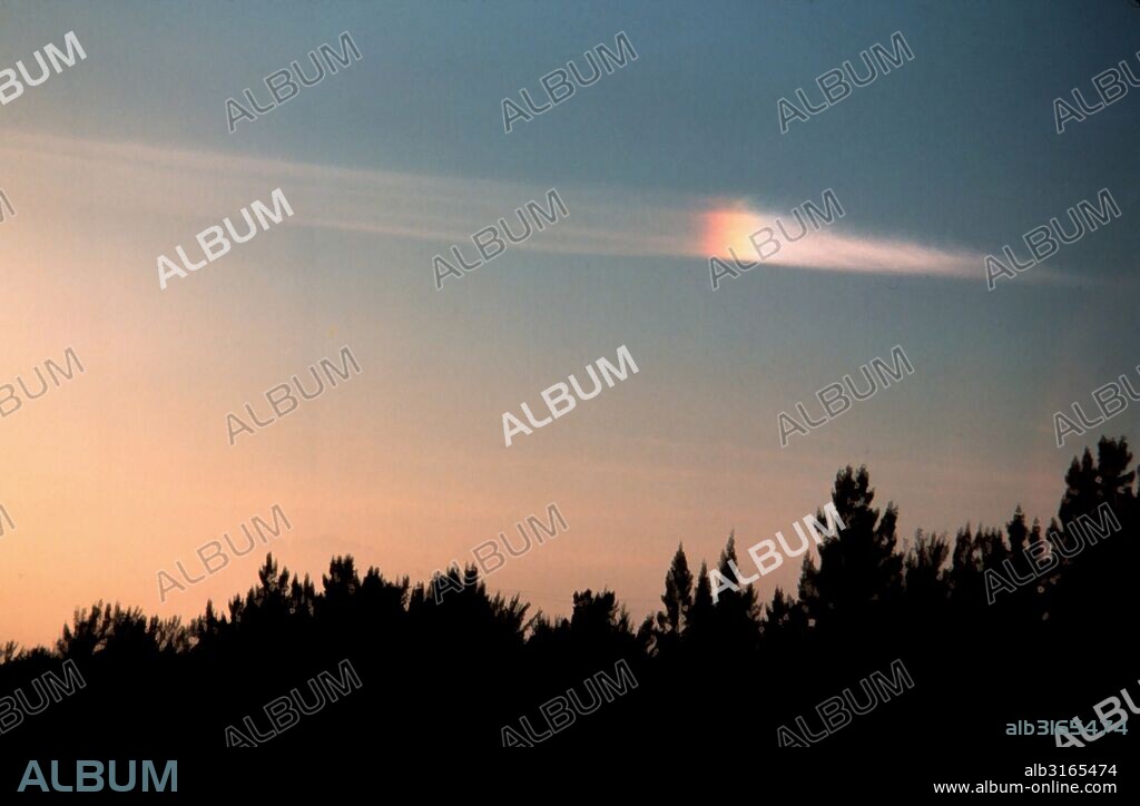 Photograph of a Parhelion, an atmospheric phenomenon that consists of a pair of bright spots on either side on the Sun, often co-occurring with a luminous ring. Photographed by Ralph F. Kresge. Dated 1978.