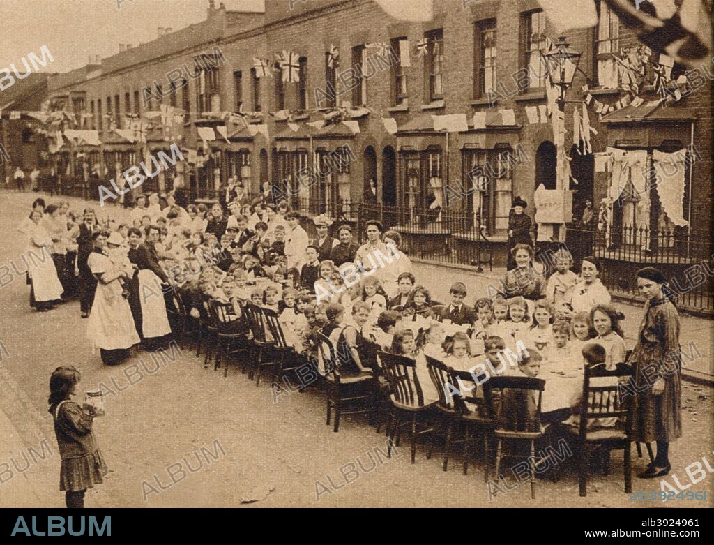 ' A children's tea party in an East End Street in London, to celebrate the Treaty of Versailles at the end of the First World War', 1919, (1938). From These Tremendous Years 1919-1938. [Daily Express, London, 1938].