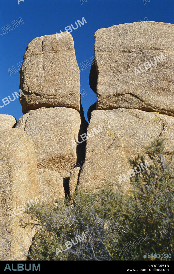 An excellent example of the monzogranitic joint system in Joshua Tree National Park, California. Eons of erosion have exposed these plutonic intrusions, and now freeze/thaw cycles and wind and water erosion are forming rounded rock piles.