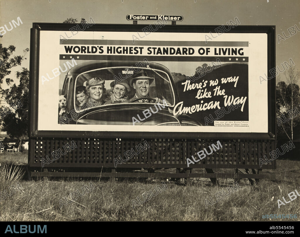 DOROTHEA LANGE. Billboard on U.S. Highway 99 in California. National advertising campaign sponsored by National Association of Manufacturers. [White family and pet on a car journey during the Great Depression, a period of high unemployment: 'World's Highest Standard of Living - There's no way like the American Way. The use of this panel donated by Foster and Kleiser Company'].