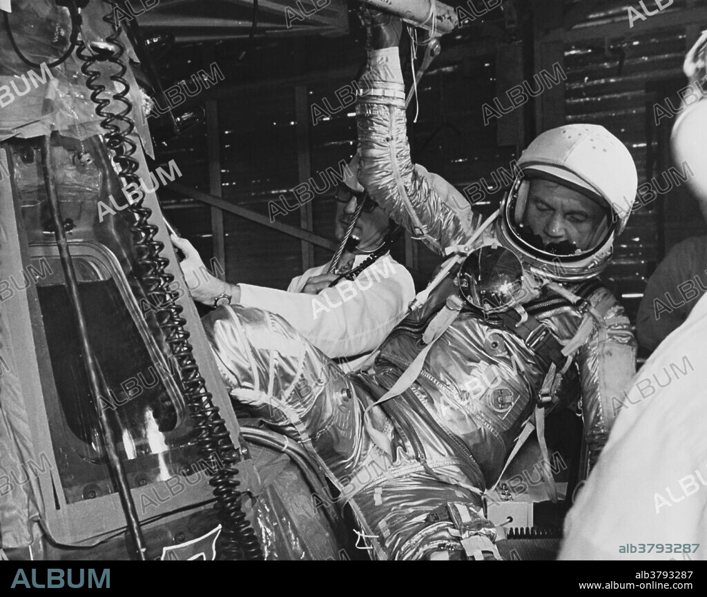 Astronaut John Glenn (1921-2106) climbs into the Mercury-Atlas 6 spacecraft Friendship 7 during pre-launch checkout procedures; 1962. MA-6 was the first time NASA placed an astronaut into orbit.
