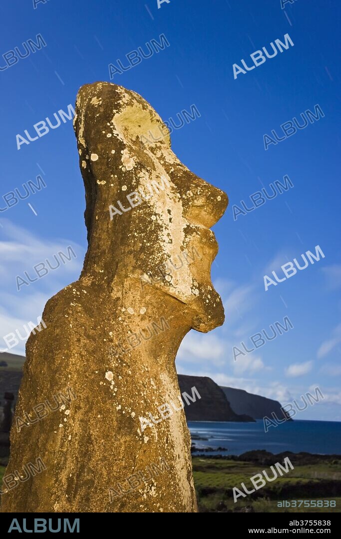 Lone monolithic giant stone Moai statue looking out to sea at Tongariki, Rapa Nui (Easter Island), UNESCO World Heritage Site, Chile, South America.