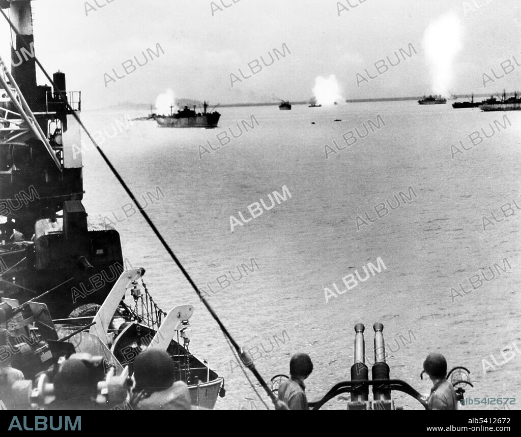 Crashes of three Japanese kamikaze planes on three U.S. ships, off Leyte in November 1944. Note anti-aircraft batteries on alert in foreground. Kamikaze were a part of the Japanese Special Attack Units of military aviators who initiated suicide attacks for the Empire of Japan against Allied naval vessels in the closing stages of the Pacific campaign of WWII, designed to destroy warships more effectively than possible with conventional air attacks. About 3,800 kamikaze pilots died during the war, and more than 7,000 naval personnel were killed by kamikaze attacks. Kamikaze aircraft were essentially pilot-guided explosive missiles. (cropped and cleaned).