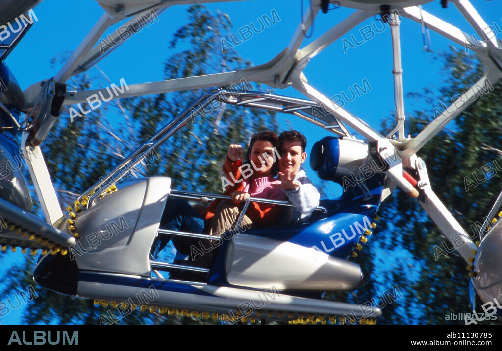 Singer Oliver Petszokat and actress Tatiani Katrantzi on a carousel during a visit to an amusement park, Germany 1997. (original german headline: Oliver Petszokat, Tatiani Katrantzi).