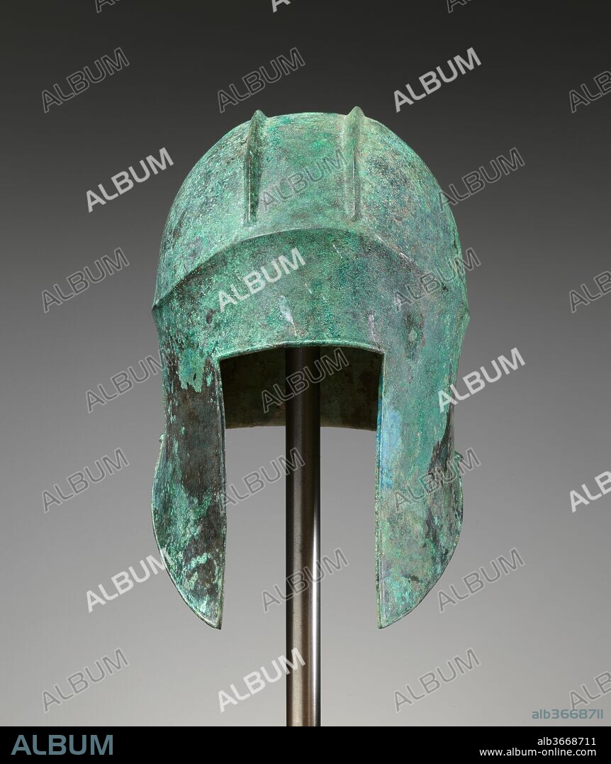 Bronze helmet of Illyrian type. Culture: Greek. Dimensions: Height 26 cm (from cheek guard to crown). Date: 5th or early 4th century B.C..
The Illyrian helmet was a popular type in the Classical period. A similiar helmet with the elaborate plumed crest that was once attached between the ridges on the top appears on silver tetraobols of the Macedonian King Perdiccas II (ca. 454-413 B.C.).