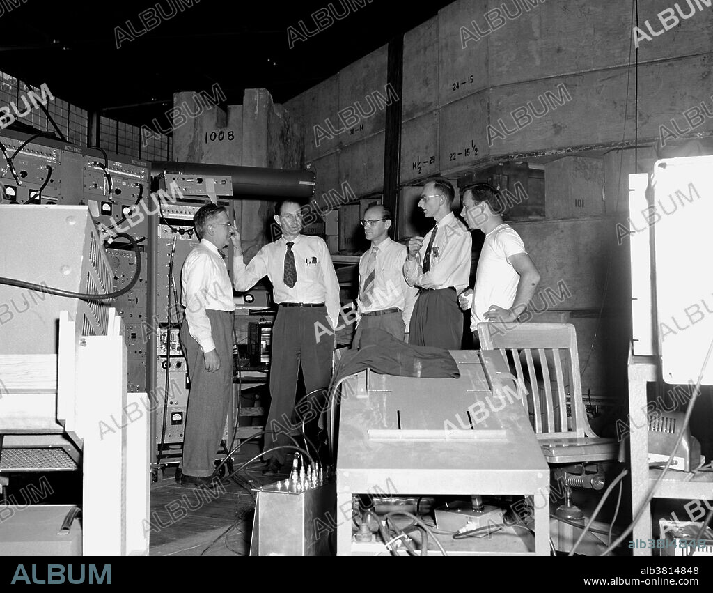 Left to right: Emilio Segre, Clyde Wiegand, Edward Lofgren (not part of the team, Director of LBNL), Owen Chamberlain and Tom Ypsilantis (graduate student). The photograph was taken at Lawrence Berkeley Laboratory in October, 1955 at the time of the discovery of the antiproton. The antiproton is the antiparticle of the proton. An antiproton consists of two up antiquarks and one down antiquark. The properties of the antiproton that have been measured all match the corresponding properties of the proton, with the exception that the antiproton has electric charge and magnetic moment that are the opposites of those in the proton. The antiproton was experimentally confirmed in 1955 by University of California, Berkeley physicists Emilio SegrÃ¨ and Owen Chamberlain, for which they were awarded the 1959 Nobel Prize in Physics.