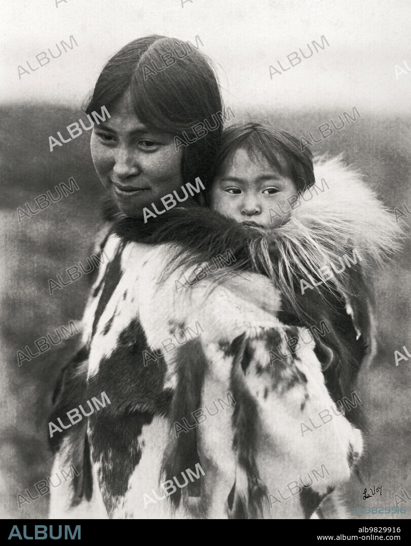 Alaska circa 1920, An Eskimo mother carrying her papoose on her back.