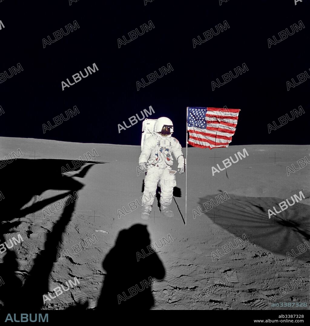 Astronaut Edgar D. Mitchell, lunar module pilot for the Apollo 14 lunar landing mission, stands by the deployed U.S. flag on the lunar surface during the early moments of the first extravehicular activity (EVA) of the mission. He was photographed by astronaut Alan B. Shepard Jr., mission commander.