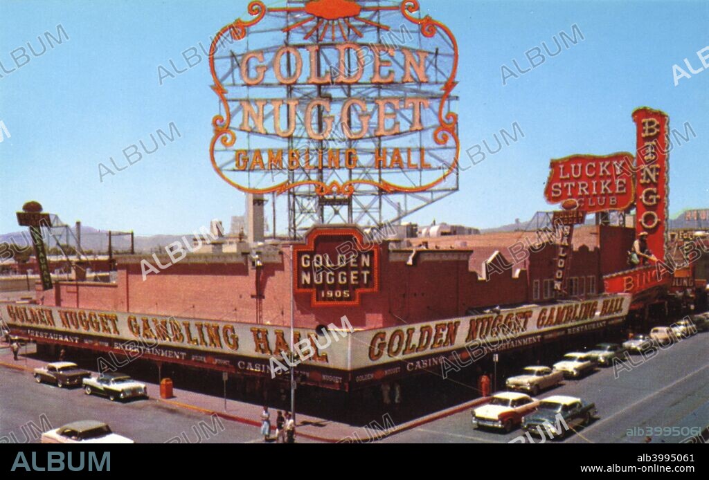 The Golden Nugget casino, Las Vegas, Nevada, USA, 1956. Vintage postcard showing the exterior of the Golden Nugget Gambling Hall. There is a huge neon sign towering over the building and another neon sign wraps around the street side of the building. Cars travel the streets. The Golden Nugget first opened in 1946, making it one of the oldest casinos in Las Vegas.