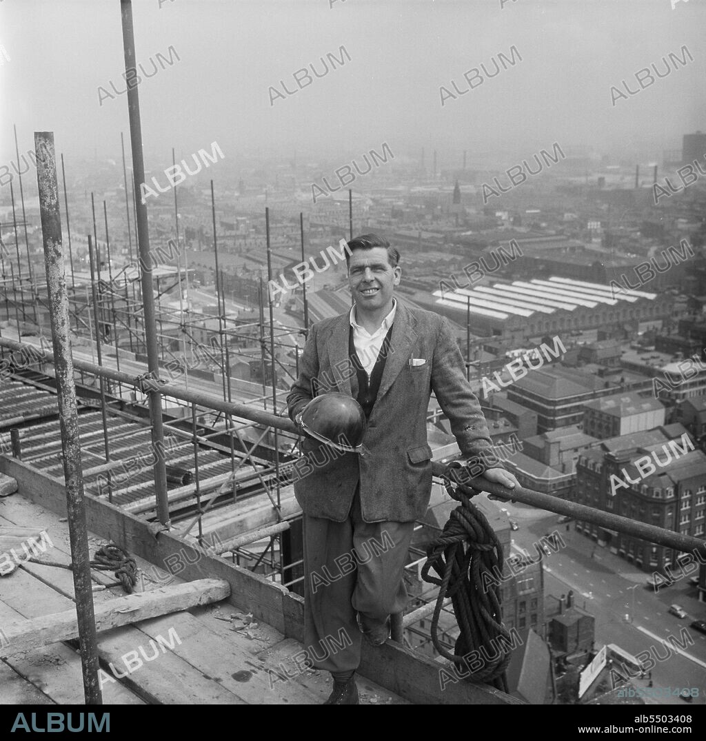 JOHN LAING PLC. CIS Building, Cooperative Insurance Society Tower, Miller Street, Manchester, 07/06/1961. Bill Whelan, a Weitz G.60 tower crane driver, posed on the construction site of the Co-operative Insurance Society (CIS) Building in front of a view across Manchester. In 1959, the Laing Company began work on the construction of two office blocks for the Co-operative Society in Manchester. The Co-operative Insurance Society (CIS) tower was over 350ft high when completed in 1962, and was the tallest office block in the country at the time. On an adjacent site, a smaller 14-storey high office block for the Co-operative Wholesale Society (CWS) was constructed simultaneously.