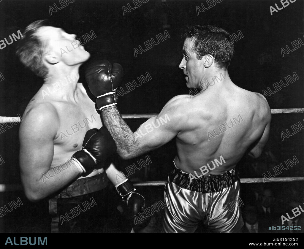 United States:  c. 1953. A boxer greets his opponent with a sharp uppercut to the jaw.