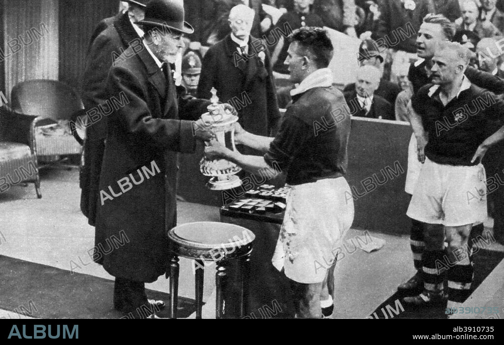King George V presenting the FA Cup, Wembley Stadium, London, c1923-1936 (1937). A print from The Story of Seventy Momentous Years, the Life and Times of King George V, 1865-1936, editor Harold Wheeler, Odhams Press Ltd, London, 1937.