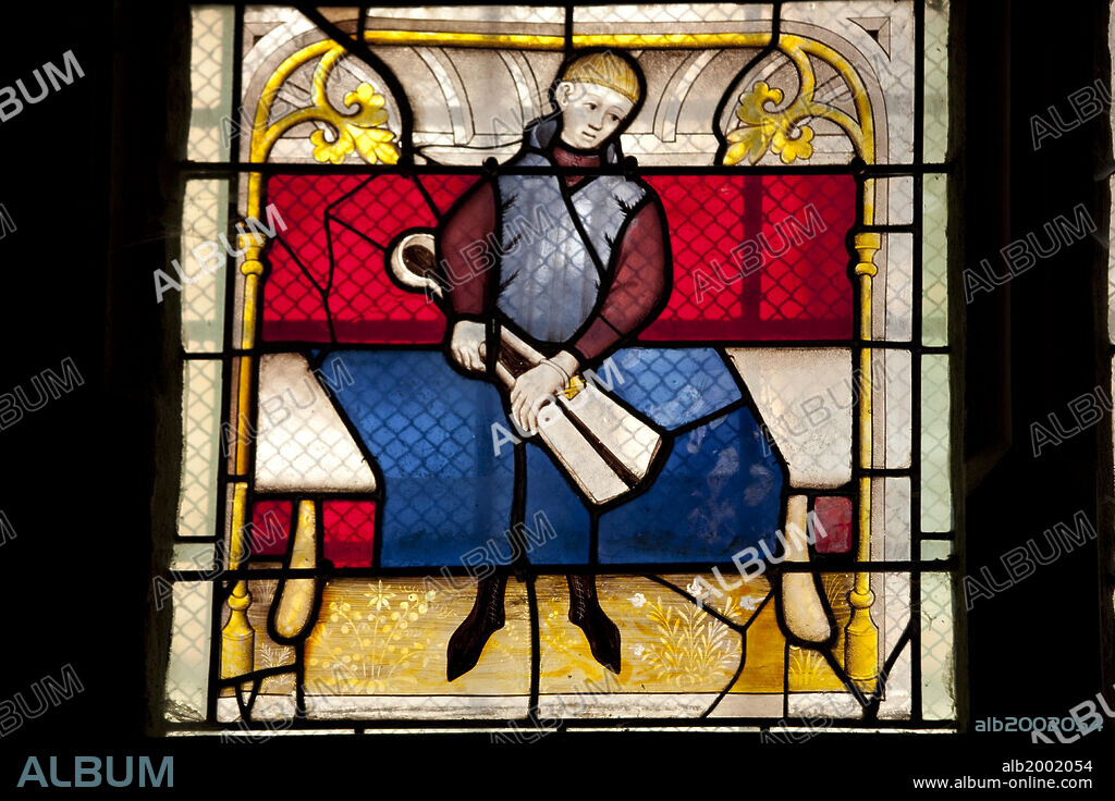 Notre-Dame of Semur-En-Auxois is considered as a remarkable example of the Gothic art. Most parts of the edifice date from the first half of the 13th century. Until the beginning of the 18th century, Notre-Dame remained a priory church, used by Benedictine monks. During the revolution it became a temple to the Goddess Reason.  Notre-Dame was restored in the middle of the 19th century, by the famous architect Viollet-Le-Duc. Adorned with vivid colors, like in the Middle Ages, Our Lady's chapel contains a 14th century inspired statue. The 13th century stained glass windows can be easily recognized by the intense crimson and deep blue. Seen here is a stained glass window with scenes of the cloth merchant's work.